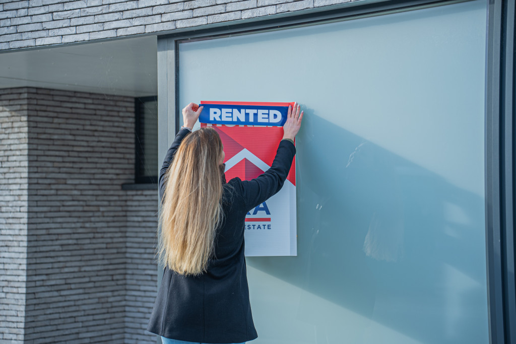 Rented sign in front of a house