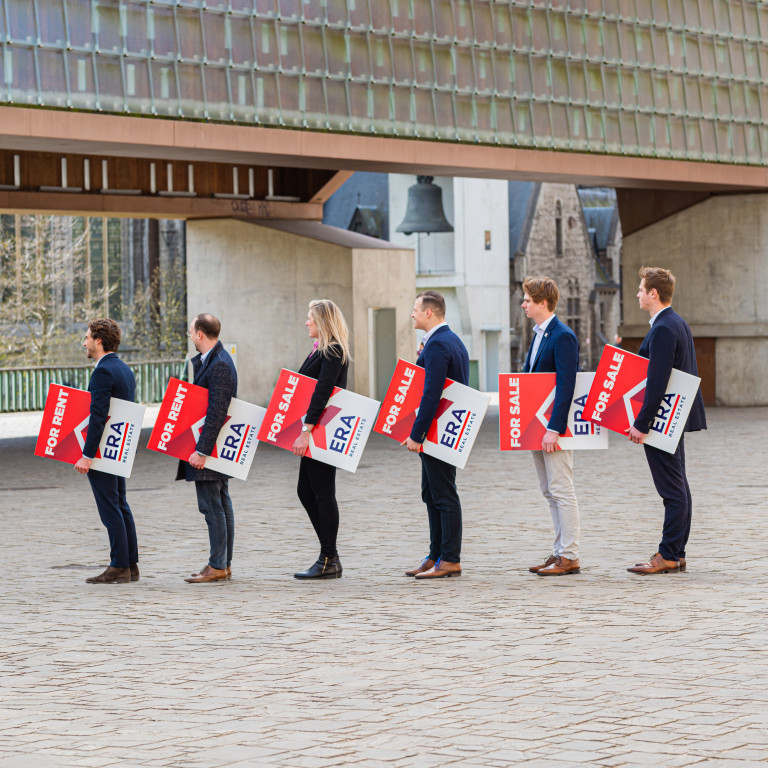 Several ERA brokers stand side by side, each holding an ERA V-Board.