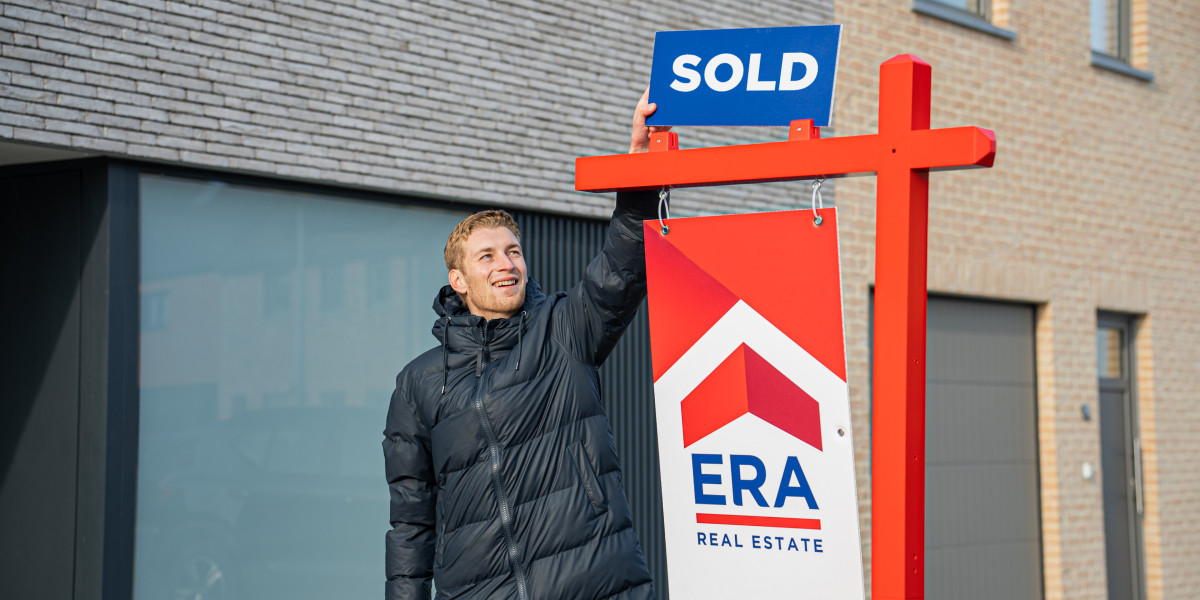 A man puts a sticker, with the word sold on an ERA billboard.