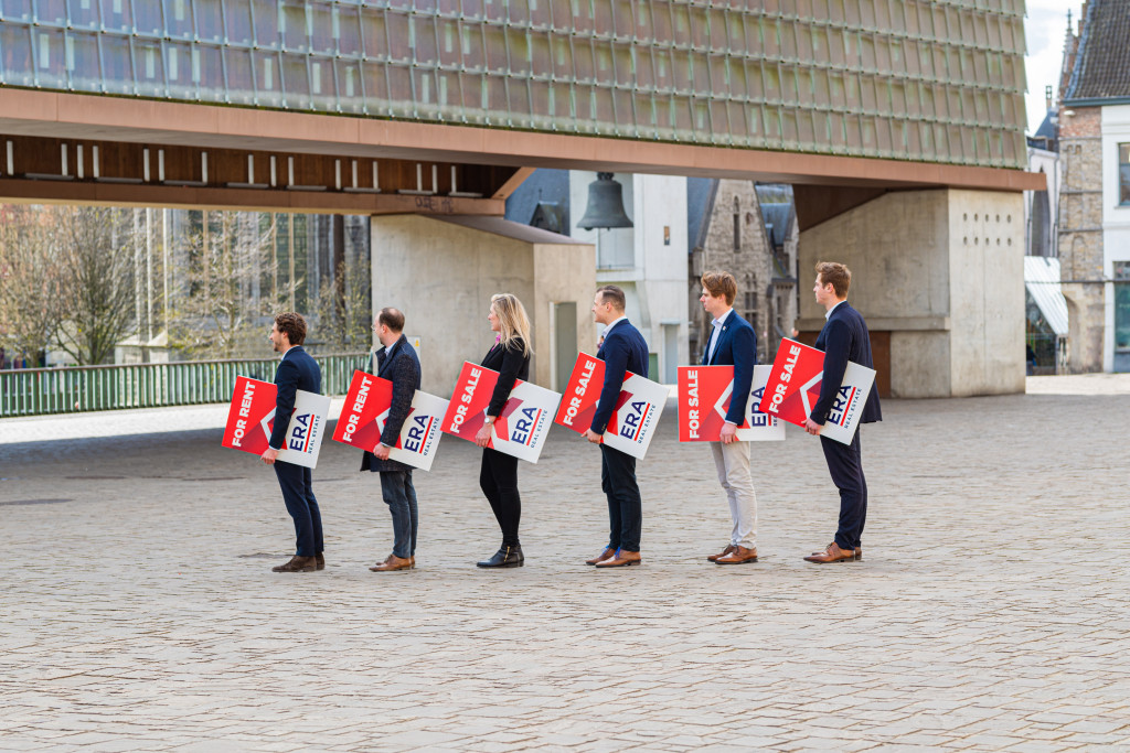Several ERA brokers stand side by side, each holding an ERA V-Board.
