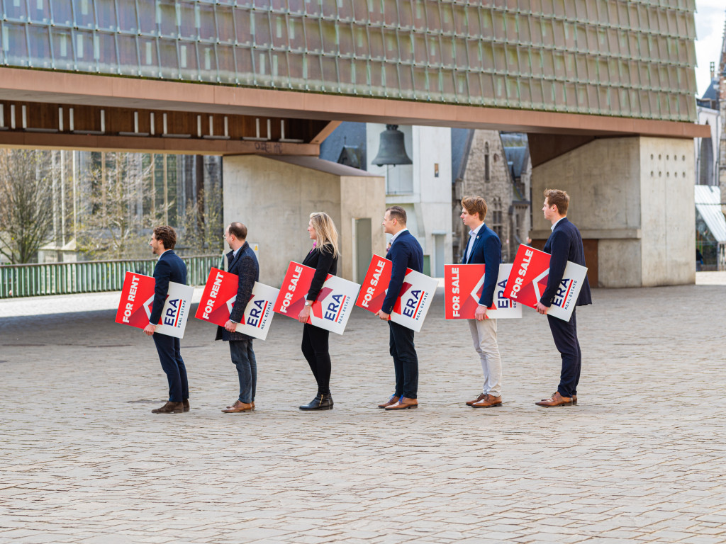 Several ERA brokers stand side by side, each holding an ERA V-Board.